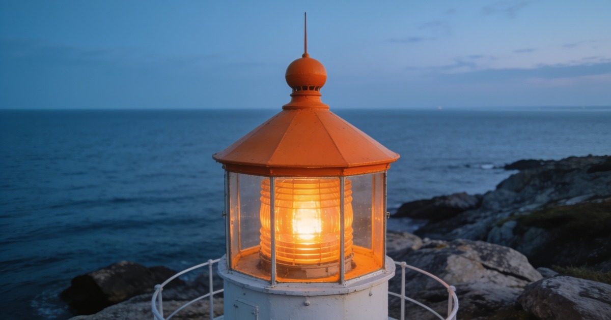 Glowing orange lighthouse lantern on a rocky coast at dusk, symbolizing constant monitoring of payroll data